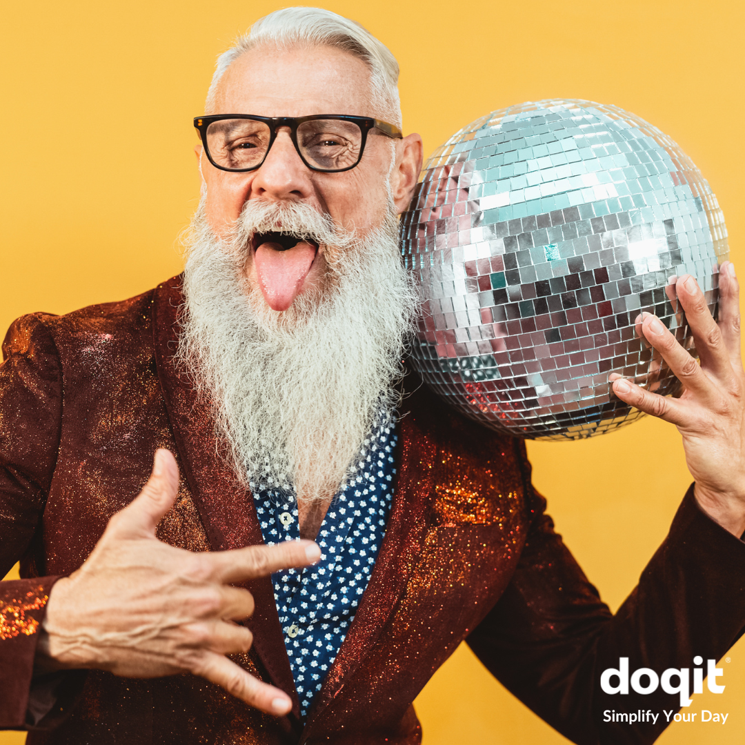 Image shows trendy older gent with long beard holding disco ball. He is wearing glasses and sticking his tongue out.