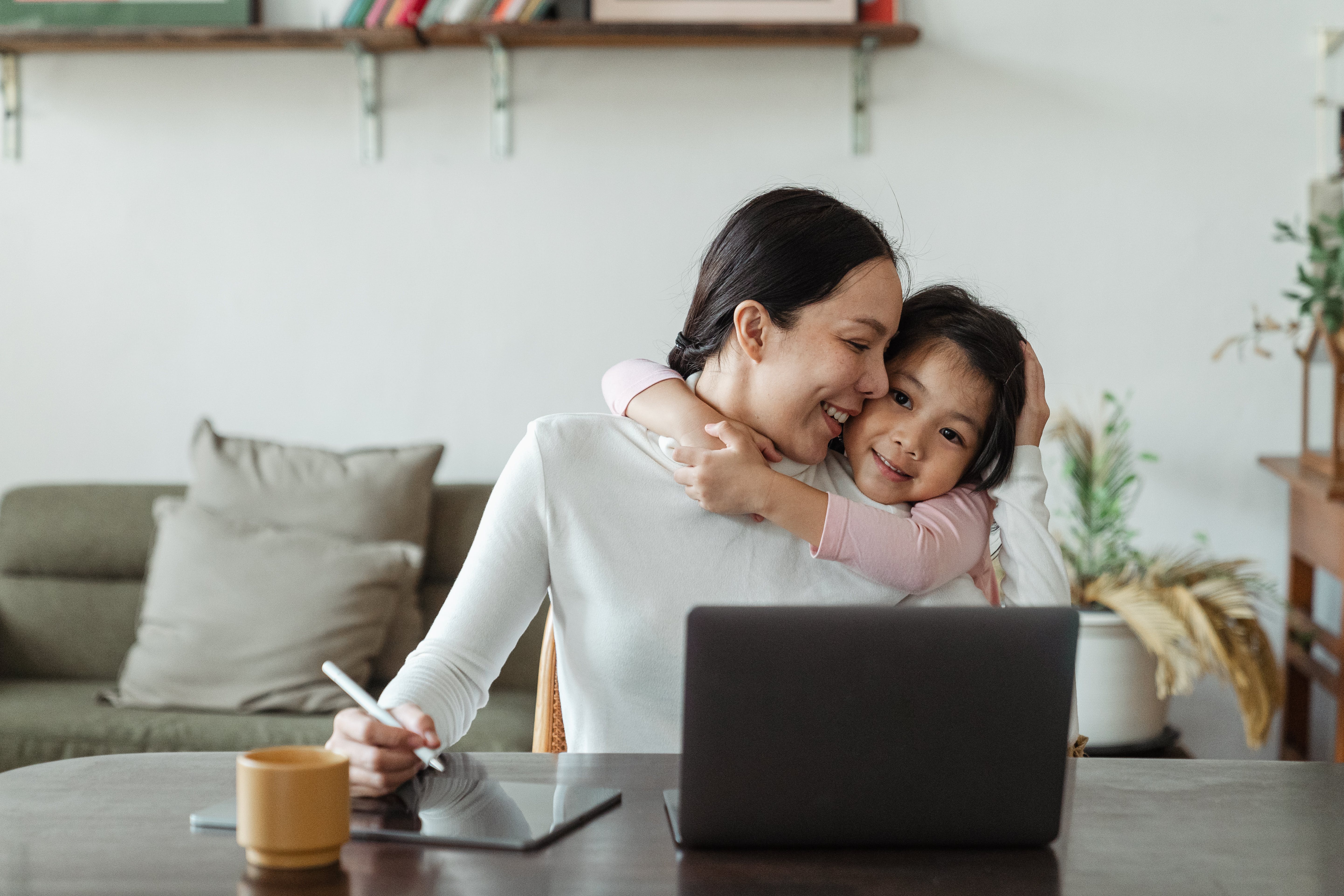 A mum with her daughter working at her computer